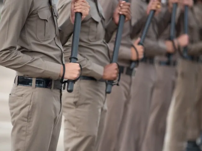 guards holding batons